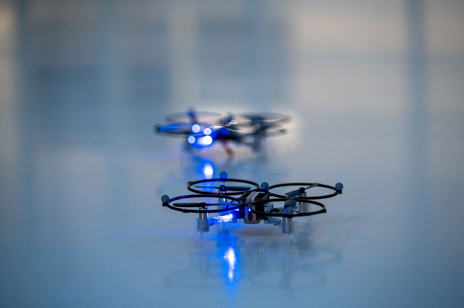 Drones on the floor prepare to takeoff.